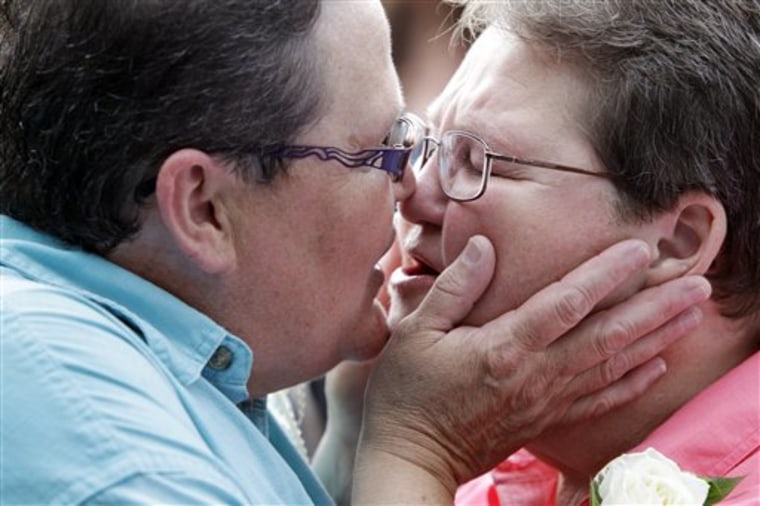 Candy Casey, left, kisses Diane Wnek, after a group same-sex marriage in Niagara Falls on Monday.